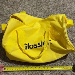 Glossier yellow duffel bag